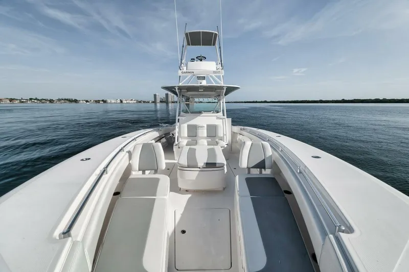 Good Times Yacht Photos Pics 2020 Invincible 42' Open Fisherman boat on calm water, clear sky background.