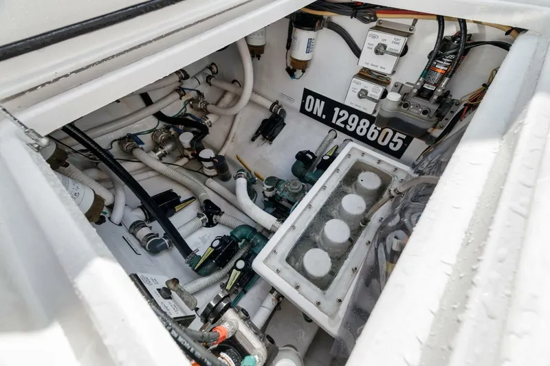 Good Times Yacht Photos Pics Engine compartment of a 2020 Invincible 42' Open Fisherman boat, showcasing intricate wiring and components.