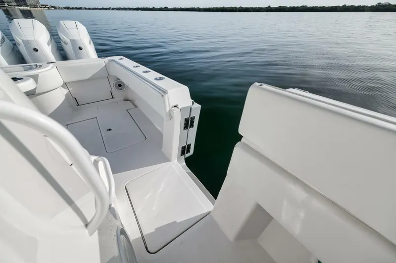 Good Times Yacht Photos Pics 2020 Invincible 42' Open Fisherman boat deck with triple outboard motors on calm water.