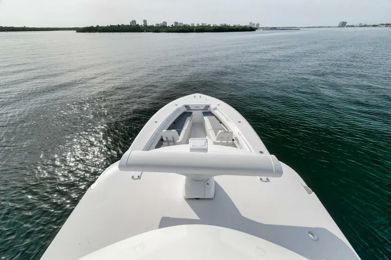 Good Times Yacht Photos Pics 2020 Invincible 42' Open Fisherman boat on calm water, city skyline in background.