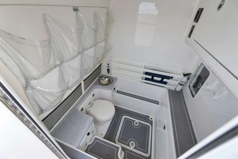 Good Times Yacht Photos Pics 2020 Invincible 42' Open Fisherman boat interior with toilet and storage compartments.