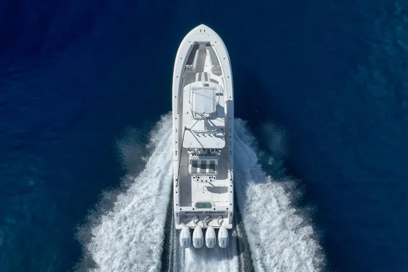 Good Times Yacht Photos Pics 2020 Invincible 42' Open Fisherman boat cruising on blue ocean waters.