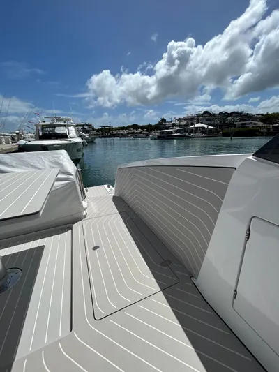  Yacht Photos Pics 2024 Azimut Verve 48 yacht docked, showcasing sleek deck design under a bright blue sky.