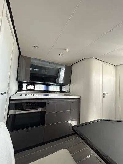  Yacht Photos Pics 2024 Azimut Verve 48 yacht interior kitchen with modern appliances and sleek design.