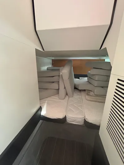  Yacht Photos Pics 2024 Azimut Verve 48 interior cabin with stacked cushions and modern design.