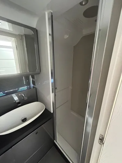  Yacht Photos Pics 2024 Azimut Verve 48 yacht bathroom with modern sink and enclosed shower.