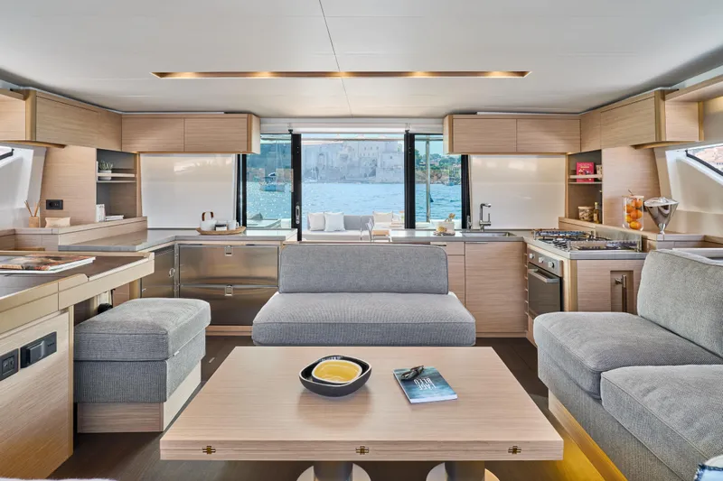  Yacht Photos Pics Luxurious interior of 2026 Lagoon 51 Owners version yacht with modern kitchen and seating area.