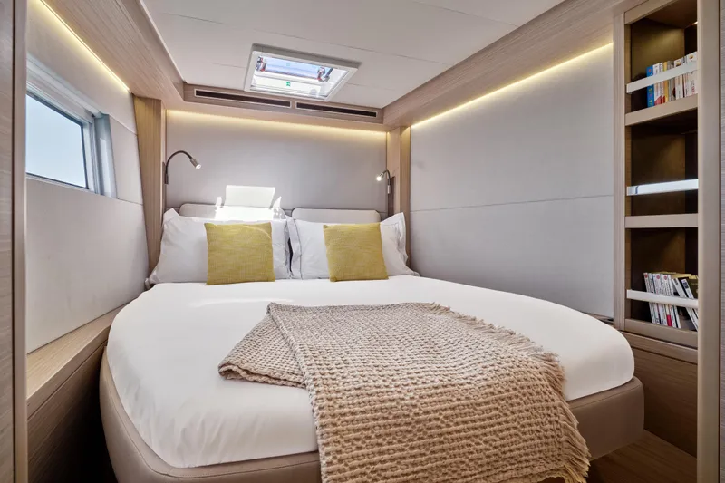  Yacht Photos Pics Luxurious bedroom in 2026 Lagoon 51 Owners version yacht with modern design and cozy bedding.