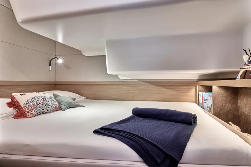 Yacht Photos Pics Luxurious bedroom in 2026 Lagoon 51 Owners version yacht, featuring modern design and cozy bedding.