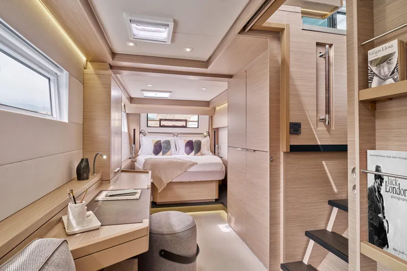  Yacht Photos Pics Luxurious interior of 2026 Lagoon 51 Owners version yacht, featuring modern design and cozy bedroom.