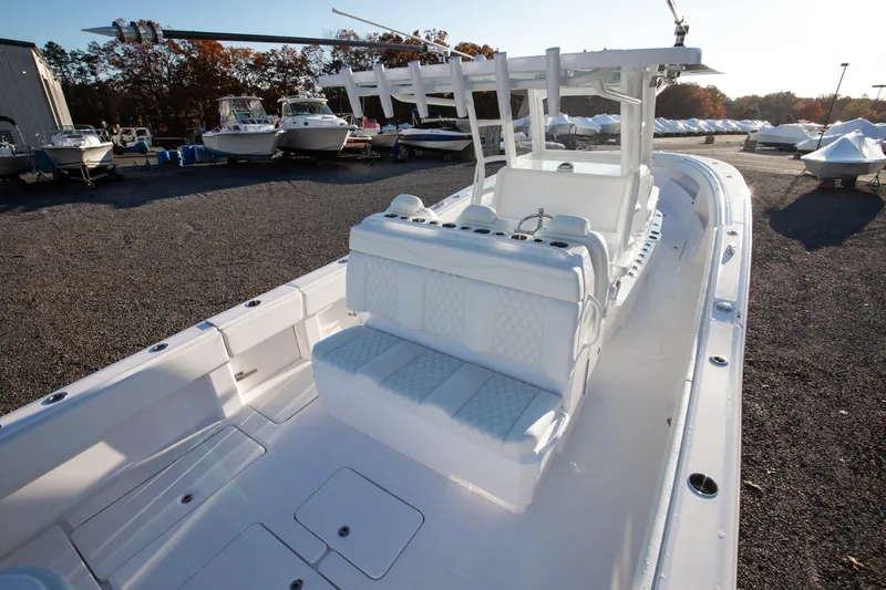  Yacht Photos Pics 2024 Invincible 39 Open Fisherman boat, spacious deck, white seating, docked with other boats.