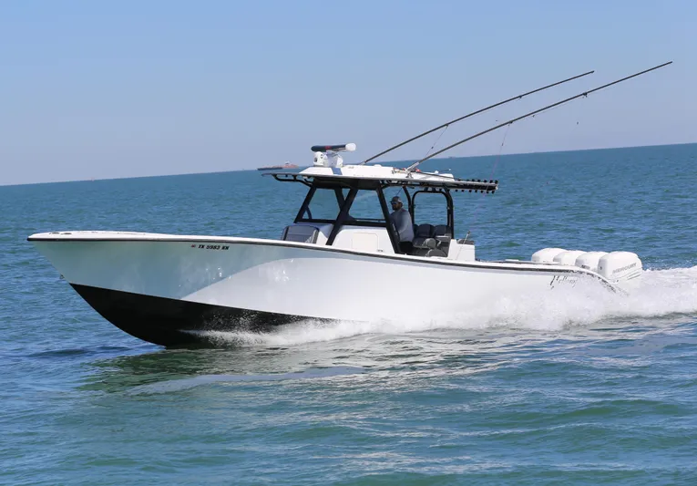  Yacht Photos Pics 2018 Yellowfin 39 boat cruising on open water with fishing rods.