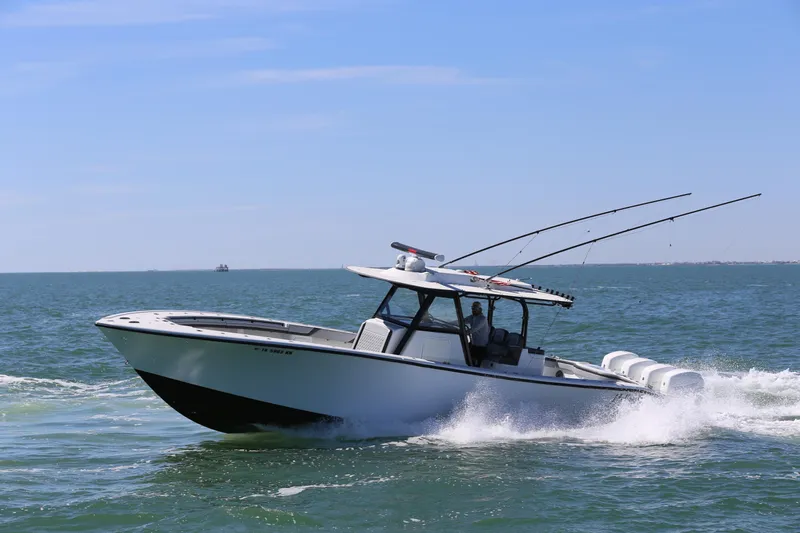  Yacht Photos Pics 2018 Yellowfin 39 boat cruising on open water, equipped with fishing rods.