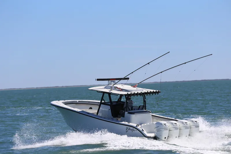  Yacht Photos Pics 2018 Yellowfin 39 boat cruising on open water with fishing rods.
