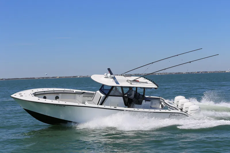  Yacht Photos Pics 2018 Yellowfin 39 boat cruising on open water, equipped with multiple outboard engines.