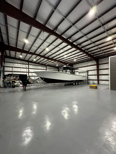  Yacht Photos Pics 2018 Yellowfin 39 boat inside a spacious, well-lit warehouse.