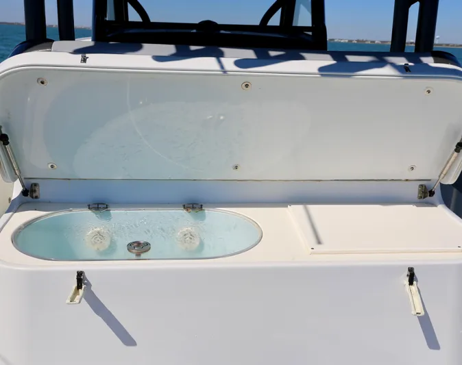  Yacht Photos Pics 2018 Yellowfin 39 boat livewell with open lid, showcasing water and interior features.