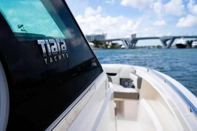 Let's Go Yacht Photos Pics 2023 Tiara Yachts 34 LS on water, bridge in background, sunny day.