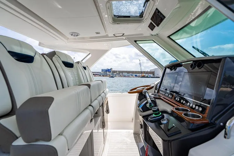 Let's Go Yacht Photos Pics 2023 Tiara Yachts 34 LS cockpit with luxurious seating and advanced navigation controls.