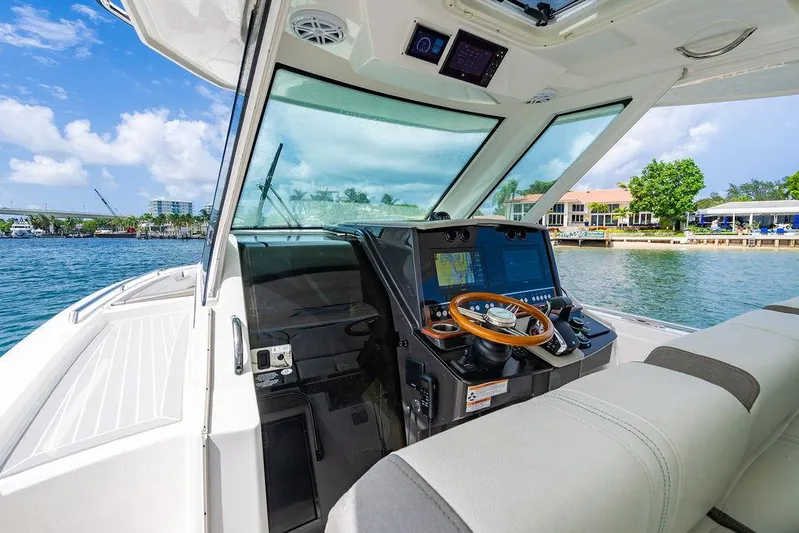 Let's Go Yacht Photos Pics 2023 Tiara Yachts 34 LS helm with navigation screens and wooden steering wheel.