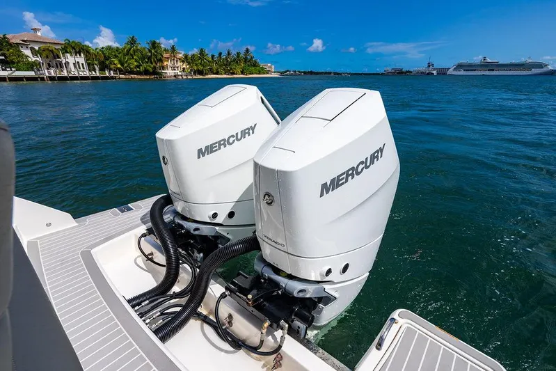 Let's Go Yacht Photos Pics 2023 Tiara Yachts 34 LS with dual Mercury outboard engines on a sunny waterfront.