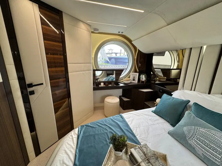 4 Stateroom Layout Yacht Photos Pics Luxurious 2024 Aicon 66 Vivere yacht bedroom with elegant decor and round window view.