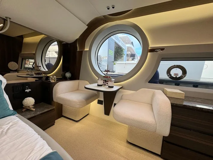 4 Stateroom Layout Yacht Photos Pics Luxurious interior of 2024 Aicon 66 Vivere yacht with elegant seating and round windows.