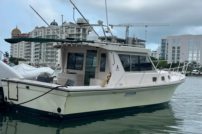  Yacht Photos Pics 2004 Albin 35 Tournament Express boat docked in marina, urban buildings in background.