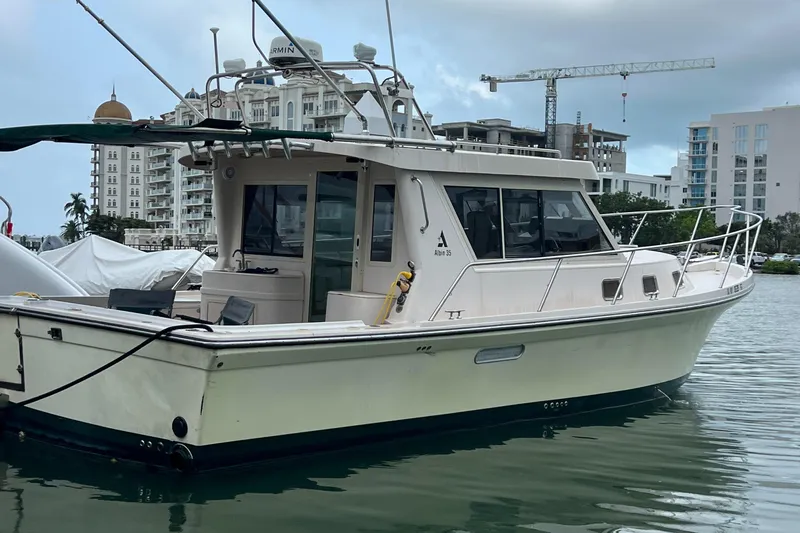  Yacht Photos Pics 2004 Albin 35 Tournament Express boat docked in a marina with cityscape background.
