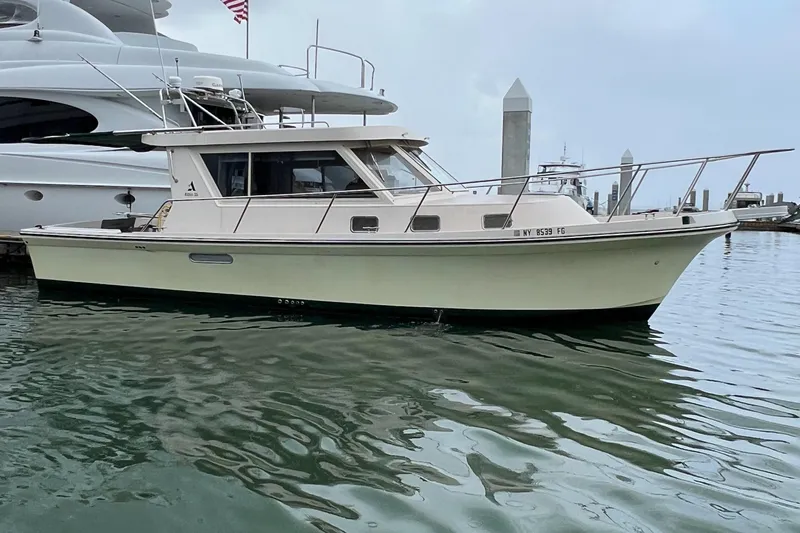  Yacht Photos Pics 2004 Albin 35 Tournament Express boat docked in marina, side view.