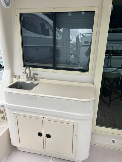  Yacht Photos Pics 2004 Albin 35 Tournament Express boat with outdoor sink and storage cabinet.