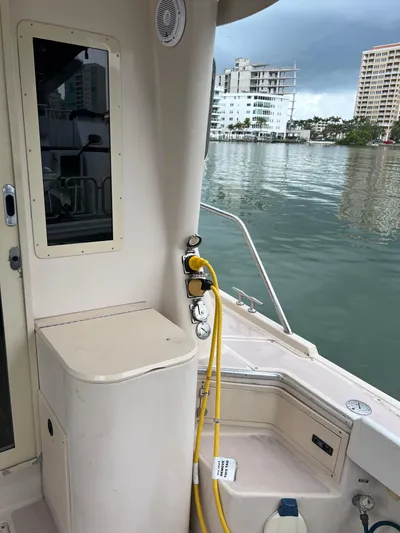  Yacht Photos Pics 2004 Albin 35 Tournament Express boat docked near waterfront buildings.