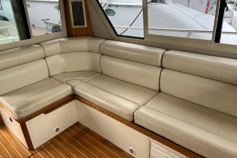  Yacht Photos Pics 2004 Albin 35 Tournament Express interior with beige leather seating and wooden flooring.