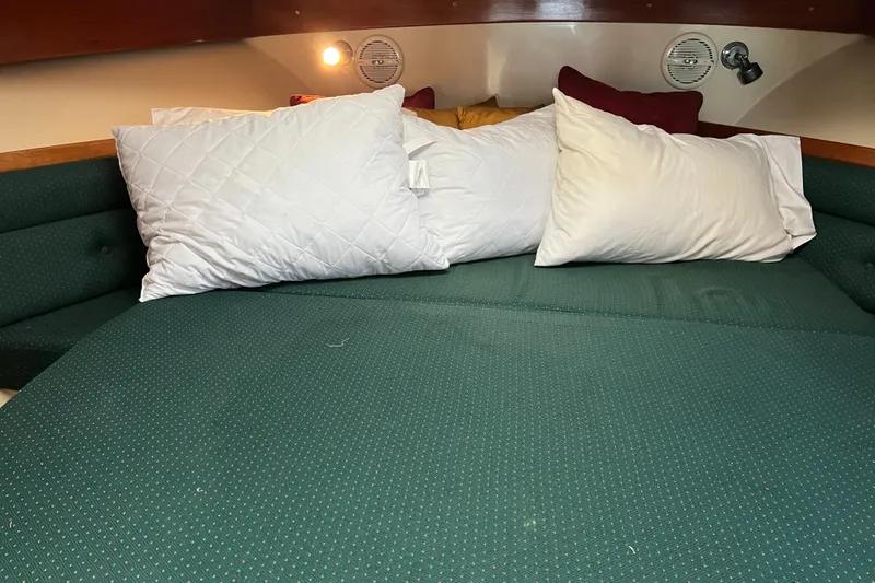  Yacht Photos Pics Cozy cabin interior of 2004 Albin 35 Tournament Express with green bedding and pillows.