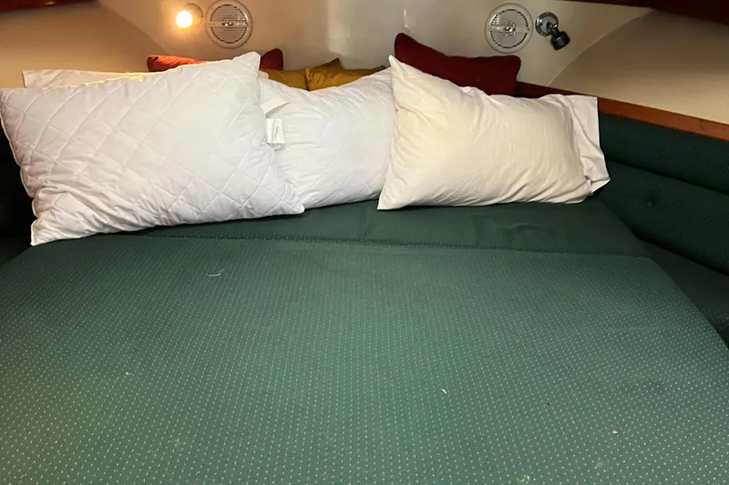  Yacht Photos Pics Cozy cabin interior of 2004 Albin 35 Tournament Express with pillows and green bedding.