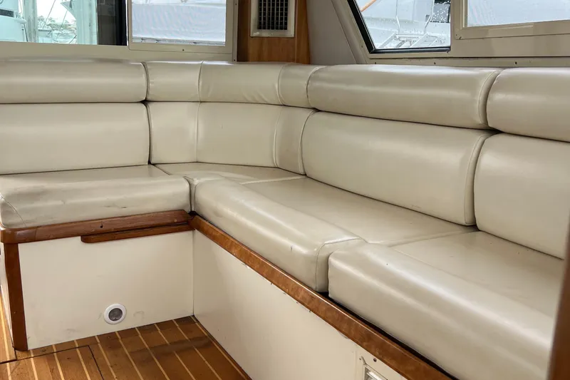  Yacht Photos Pics 2004 Albin 35 Tournament Express interior with beige leather seating and wooden flooring.