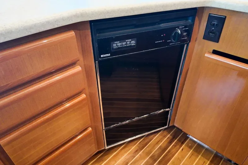 Coming To Fort Lauderdale By Nov. 3 Yacht Photos Pics 1999 Viking Cockpit Sports Yacht kitchen with built-in dishwasher and wooden cabinetry.