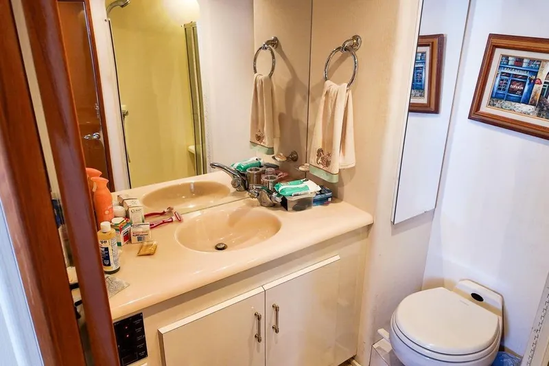 Coming To Fort Lauderdale By Nov. 3 Yacht Photos Pics Bathroom interior of 1999 Viking Cockpit Sports Yacht with dual sinks and toiletries.