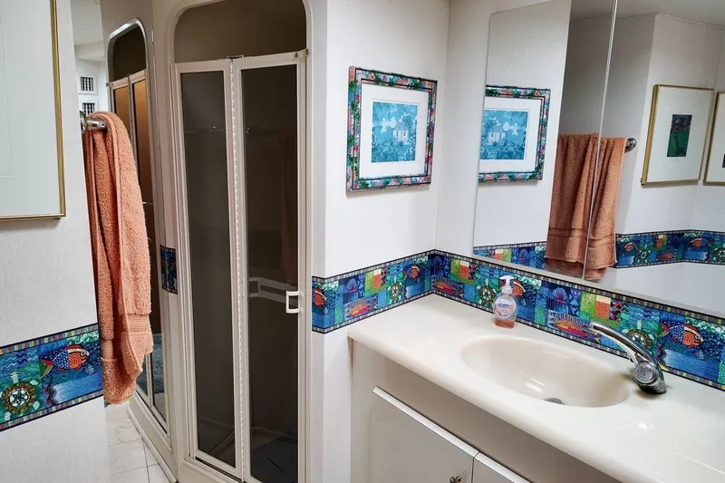 Coming To Fort Lauderdale By Nov. 3 Yacht Photos Pics Bathroom interior of 1999 Viking Cockpit Sports Yacht with colorful decor and shower.