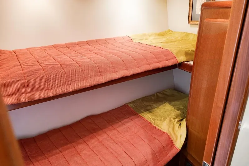 Coming To Fort Lauderdale By Nov. 3 Yacht Photos Pics Bunk beds in 1999 Viking Cockpit Sports Yacht cabin with red and yellow bedding.