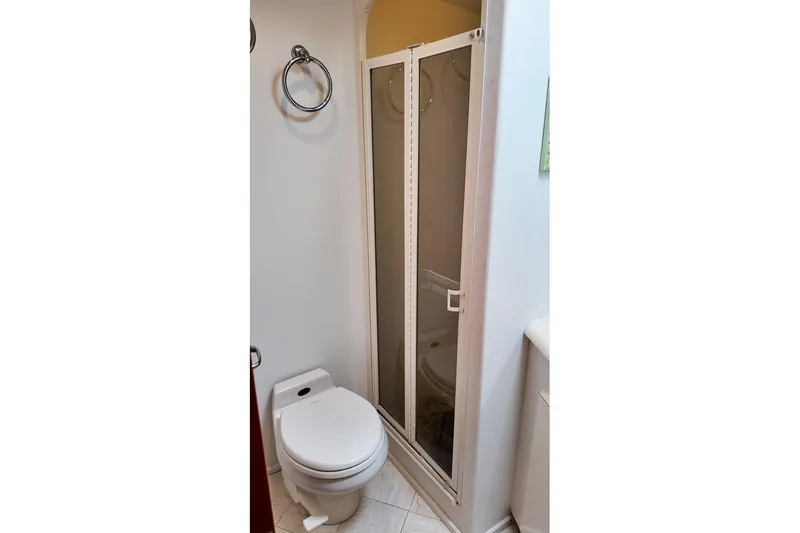 Coming To Fort Lauderdale By Nov. 3 Yacht Photos Pics Compact bathroom in 1999 Viking Cockpit Sports Yacht with shower and toilet.