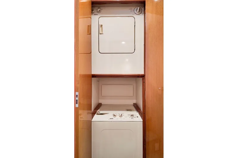 Coming To Fort Lauderdale By Nov. 3 Yacht Photos Pics Laundry area in 1999 Viking Cockpit Sports Yacht with stacked washer and dryer.