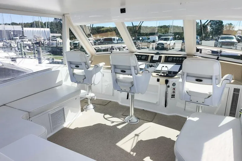 Coming To Fort Lauderdale By Nov. 3 Yacht Photos Pics 1999 Viking Cockpit Sports Yacht interior with white seating and control panel.