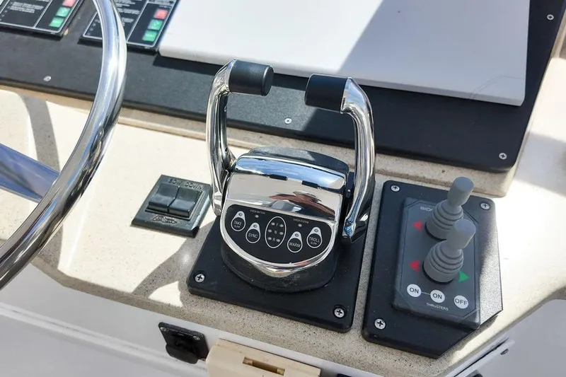 Coming To Fort Lauderdale By Nov. 3 Yacht Photos Pics Control panel of a 1999 Viking Cockpit Sports Yacht with steering wheel and throttle levers.
