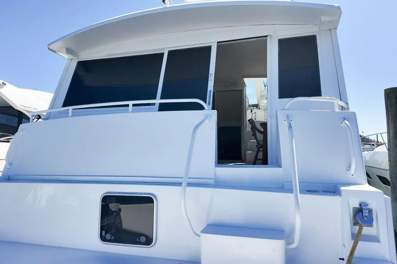 Coming To Fort Lauderdale By Nov. 3 Yacht Photos Pics 1999 Viking Cockpit Sports Yacht with open sliding doors and white exterior.