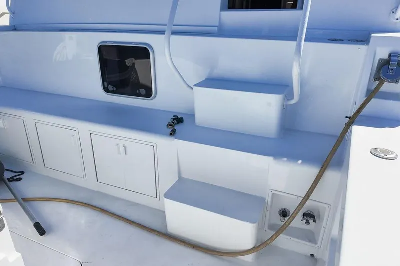 Coming To Fort Lauderdale By Nov. 3 Yacht Photos Pics 1999 Viking Cockpit Sports Yacht interior with storage cabinets and hose connection.