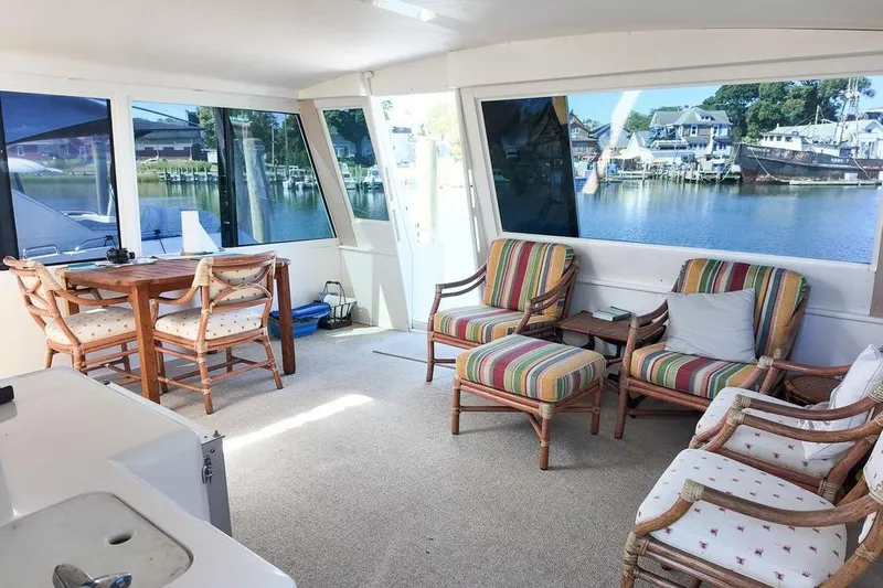 Coming To Fort Lauderdale By Nov. 3 Yacht Photos Pics 1999 Viking Cockpit Sports Yacht interior with colorful seating and waterfront view.