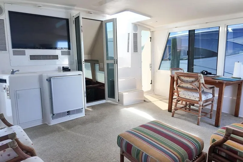 Coming To Fort Lauderdale By Nov. 3 Yacht Photos Pics Interior of 1999 Viking Cockpit Sports Yacht with seating, table, and TV.