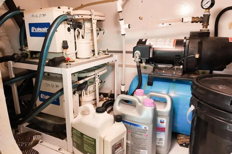 Coming To Fort Lauderdale By Nov. 3 Yacht Photos Pics Engine room of a 1999 Viking Cockpit Sports Yacht with mechanical equipment and supplies.