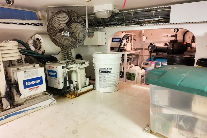 Coming To Fort Lauderdale By Nov. 3 Yacht Photos Pics Engine room of a 1999 Viking Cockpit Sports Yacht with Cruisair systems and storage containers.